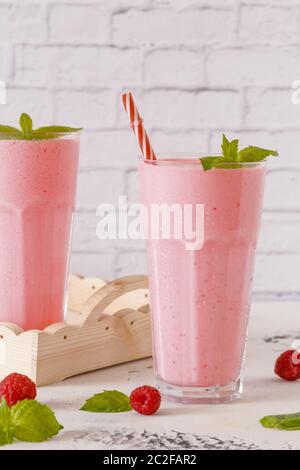 Raspberry milkshake with mint and drinking straws. Stock Photo