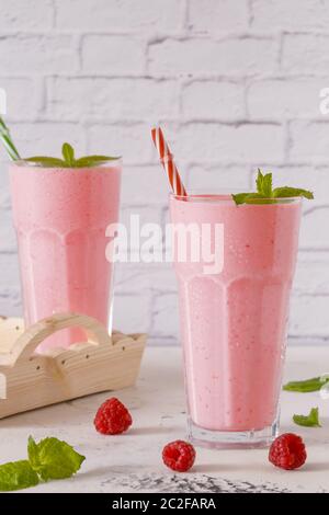 Raspberry milkshake with mint and drinking straws. Stock Photo