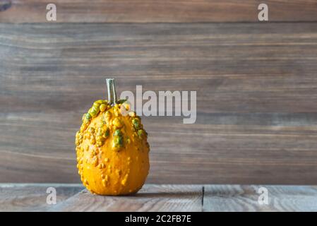 Ornamental pumpkin on the wooden background Stock Photo