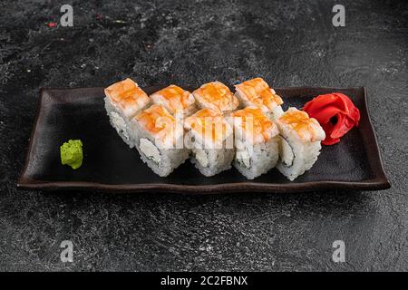 japan sushi rolls with salmon, shrimps and smoked eel with cream cheese on black platter Stock Photo