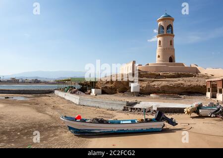 Al Ayjah Lighthouse with boats near Sur, Oman Stock Photo