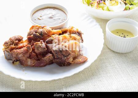 Deep fried pork knuckle with mushroom gravy source, fresh vegetable and salad cream source Stock Photo