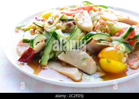 Cucumber salad with preserved pork sausages, Thai popular food called Som Tum Tang, Hot and spicy, mixed vegetables. Stock Photo