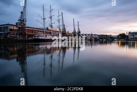 Bristol, England, UK - June 8, 2020:  The sun sets over the post-industrial Bristol Docks, including M Shed museum with its quayside cranes, and the t Stock Photo