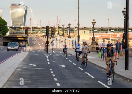 Cyclists ride along London's East-West 'Cycle Superhighway' along the River Thames Embankment at Blackfriars. Stock Photo