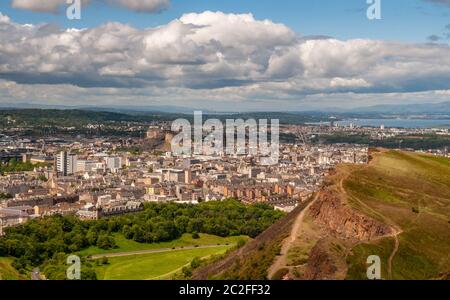 The cityscape of Edinburgh's Old Town and Southside is laid out below Arthur's Seat and Salisbury Crags in Holyrood Park. Stock Photo