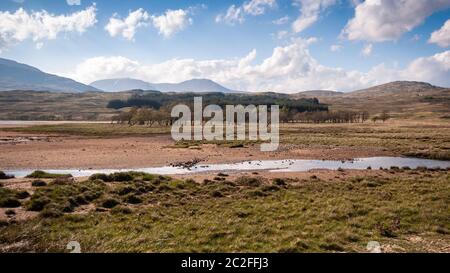 The Water of Tulla river flows from the high peat bog landscape of Rannoch Moor under the Black Mount mountains of the West Highlands of Scotland. Stock Photo