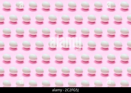 Many white eggs on solid color background Stock Photo