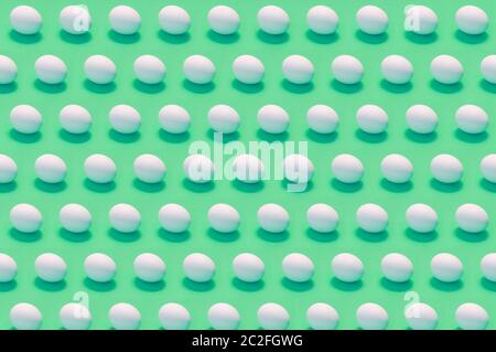 Many white eggs on solid color background Stock Photo