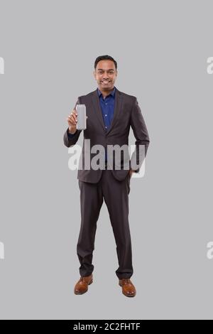 Businessman Holding Beer Tin Can. Indian Business man Standing Full Length. Stock Photo