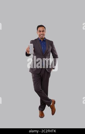 Businessman Holding Beer Tin Can. Indian Business man Standing Full Length. Stock Photo