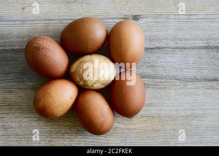 seven painted Easter eggs on a wooden background Stock Photo
