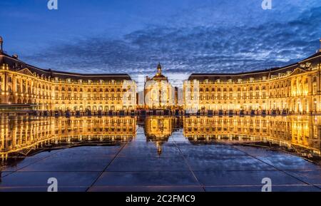 Iconic panorama of Place de la Bourse with tram and water mirror fountain in Bordeaux - France, Gironde Stock Photo