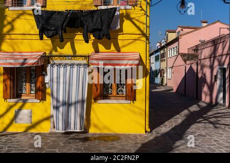 Italy, Venice, Burano, February 14 2018 Yellow house in Burano island. Stock Photo