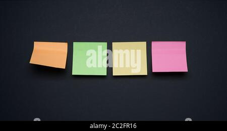 Collection of different colored sticker note papers on black background Stock Photo