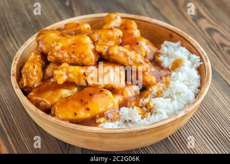 Bowl of orange chicken with white rice Stock Photo