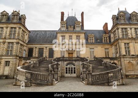 Fontainebleau, France, March 30, 2017: Royal castle of Fontainebleau. The castle is of Renaissance style, located near the downt
