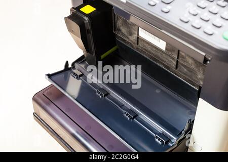 new toner cartridge in laser multi function device on pale table in office Stock Photo