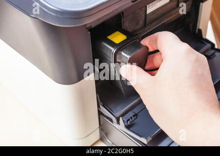 replacement of toner cartridge in laser multi function device in office Stock Photo