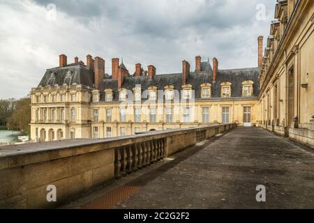 Fontainebleau, France, March 30, 2017: Royal castle of Fontainebleau. The castle is of Renaissance style, located near the downt
