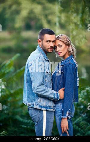 Young beautiful loving couple posing on nature Stock Photo