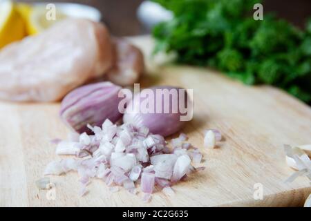 Fresh chopped shallots on a cutting board Stock Photo