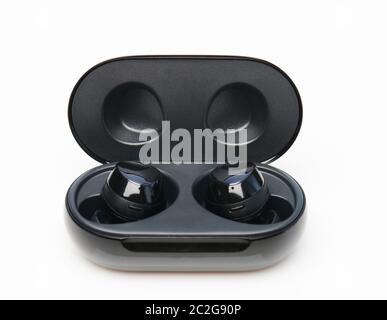 Wireless earphones with touch buttons in black case isolated Stock Photo