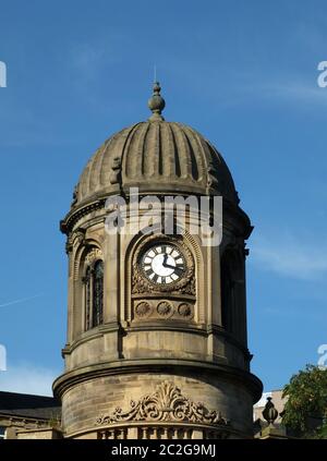 and ornate clock tower with stone cupola against a blue sky on the former sowerby bridge town hall Stock Photo