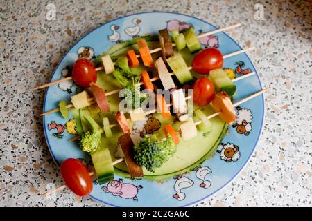 Make vegetables and fruits tasty for children with vegetable skewers. Stock Photo