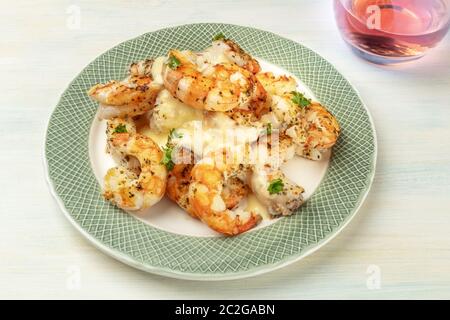 Fired shrimps with a sauce and a glass of rose wine, close-up shot Stock Photo