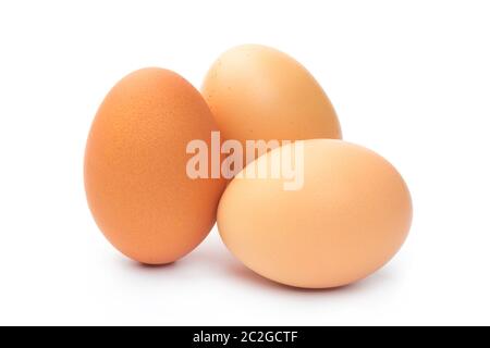 three farm brown chicken eggs on a white background Stock Photo
