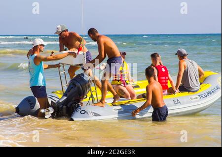 3 October 2018 A Rib pleasure craft filled with tourists coming ashore at the Oura Prai beach in Albufia on the Algarve Portugal Stock Photo