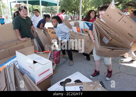 Austin Texas USA, April 20 2016: Students at Cedars International Academy, competing in the Earth Day Cardboard Challenge program at Cedars International Academy, design and build a science display out of cardboard and other simple recycled products. The event was held on Earth Day. ©Bob Daemmrich Stock Photo