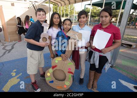 Austin Texas USA, April 20 2016: Students at Cedars International Academy, competing in the Earth Day Cardboard Challenge program at Cedars International Academy, design and build a science display out of cardboard and other simple recycled products. The event was held on Earth Day. ©Bob Daemmrich Stock Photo