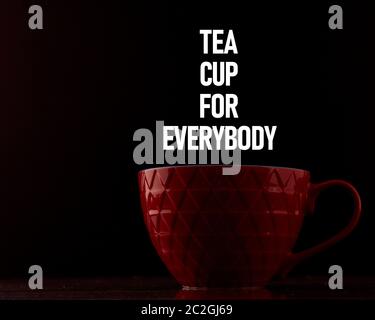 red mug on a black background with inscriptions. Design layout Stock Photo
