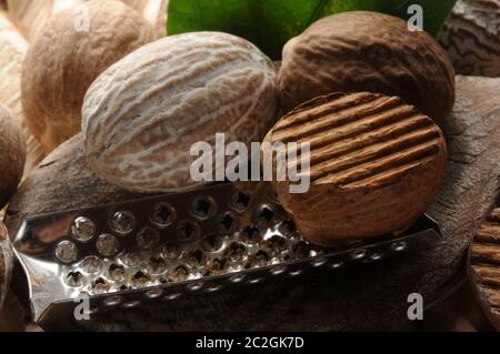Closeup of nutmegs with grater Stock Photo