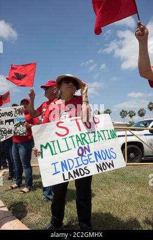 Weslaco, Texas USA< April 12, 2018: Protesters opposed to Gov. Greg Abbott's deployment of National Guard troops on the Texas border yell outside the Guard Armory in Weslaco. The guard members will assist federal Border Patrol agents in trying to slow illegal immigration at the United States' southern border. The protesters object to the government militarizing their towns. ©Bob Daemmrich Stock Photo