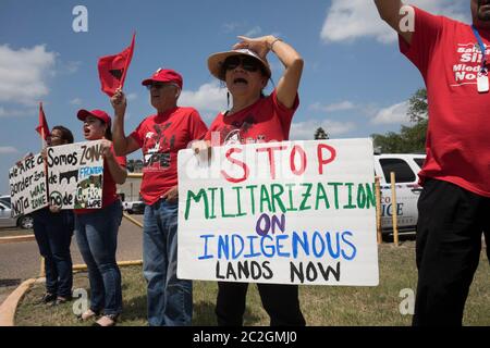 Weslaco, Texas USA< April 12, 2018: Protesters opposed to Gov. Greg Abbott's deployment of National Guard troops on the Texas border yell outside the Guard Armory in Weslaco. The guard members will assist federal Border Patrol agents in trying to slow illegal immigration at the United States' southern border. The protesters object to the government militarizing their towns. ©Bob Daemmrich Stock Photo