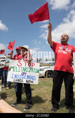 Weslaco, Texas USA< April 12, 2018: Protesters opposed to Gov. Greg Abbott's deployment of National Guard troops on the Texas border yell outside the Guard Armory in Weslaco. The guard members will assist federal Border Patrol agents in trying to slow illegal immigration at the United States' southern border. The protesters object to the government militarizing their towns. ©Bob Daemmrich Stock Photo