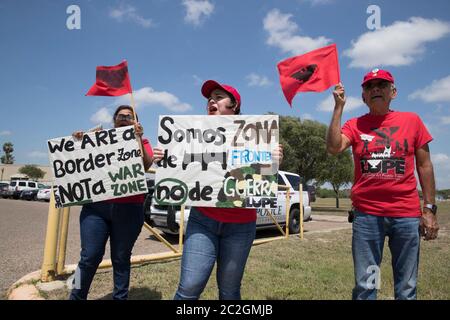 Weslaco, Texas USA< April 12, 2018: Protesters opposed to Gov. Greg Abbott's deployment of National Guard troops on the Texas border yell outside the Guard Armory in Weslaco. The guard members will assist federal Border Patrol agents in trying to slow illegal immigration at the United States' southern border. The protesters object to the government militarizing their towns. ©Bob Daemmrich Stock Photo