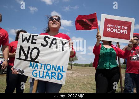 Weslaco, Texas USA< April 12, 2018: Protesters opposed to Gov. Greg Abbott's deployment of National Guard troops on the Texas border yell outside the Guard Armory in Weslaco. The guard members will assist federal Border Patrol agents in trying to slow illegal immigration at the United States' southern border. The protesters object to the government militarizing their towns. ©Bob Daemmrich Stock Photo