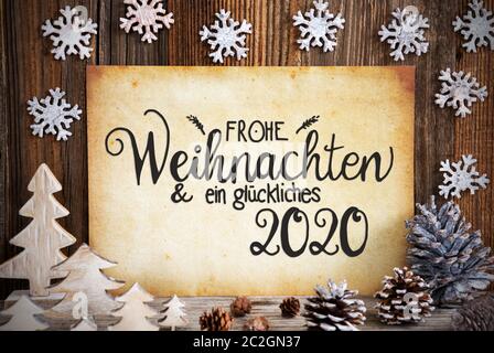 Old Paper With German Text Frohe Weihnachten Und Ein Glueckliches 21 Means Merry Christmas And Happy 21 Christmas Decoration Like Tree Fir Cone Stock Photo Alamy