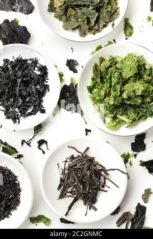 Various dry seaweed, sea vegetables, shot from above on a white background, an assortment Stock Photo