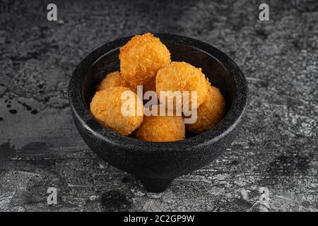 Potato croquettes - mashed potatoes balls breaded and deep fried, served with different sauce. Stock Photo