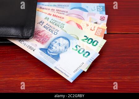 Mexican peso in the black wallet Stock Photo