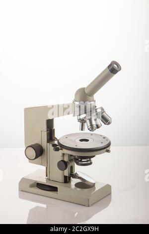 White microscope on table over white background close up Stock Photo