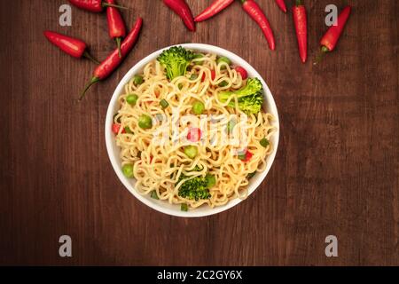 Soba noodles with green vegetables, shot from the top with red peppers Stock Photo