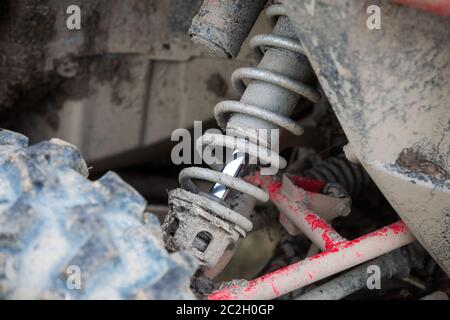 Close up shot of a muddy shock absorber of an off road car. Stock Photo