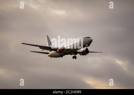 air plane in sunset sky Stock Photo
