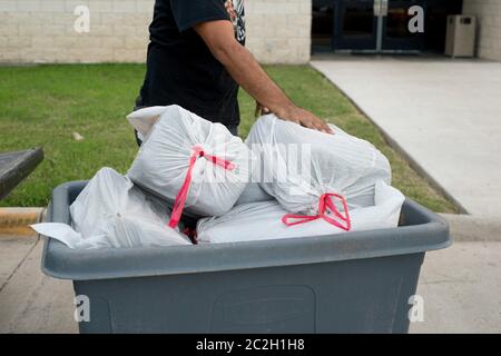 Brownsville Texas USA, September 26 2014: Large bricks of marijuana, wrapped in plastic trash bags, totaling 230 pounds seized by Cameron County undercover officers in a traffic stop of three undocumented aliens.   © Bob Daemmrich Stock Photo